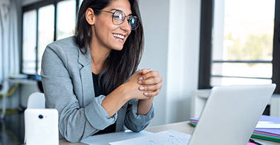 Woman smiling at laptop