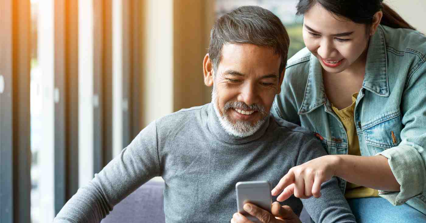 man and woman looking at phone screen